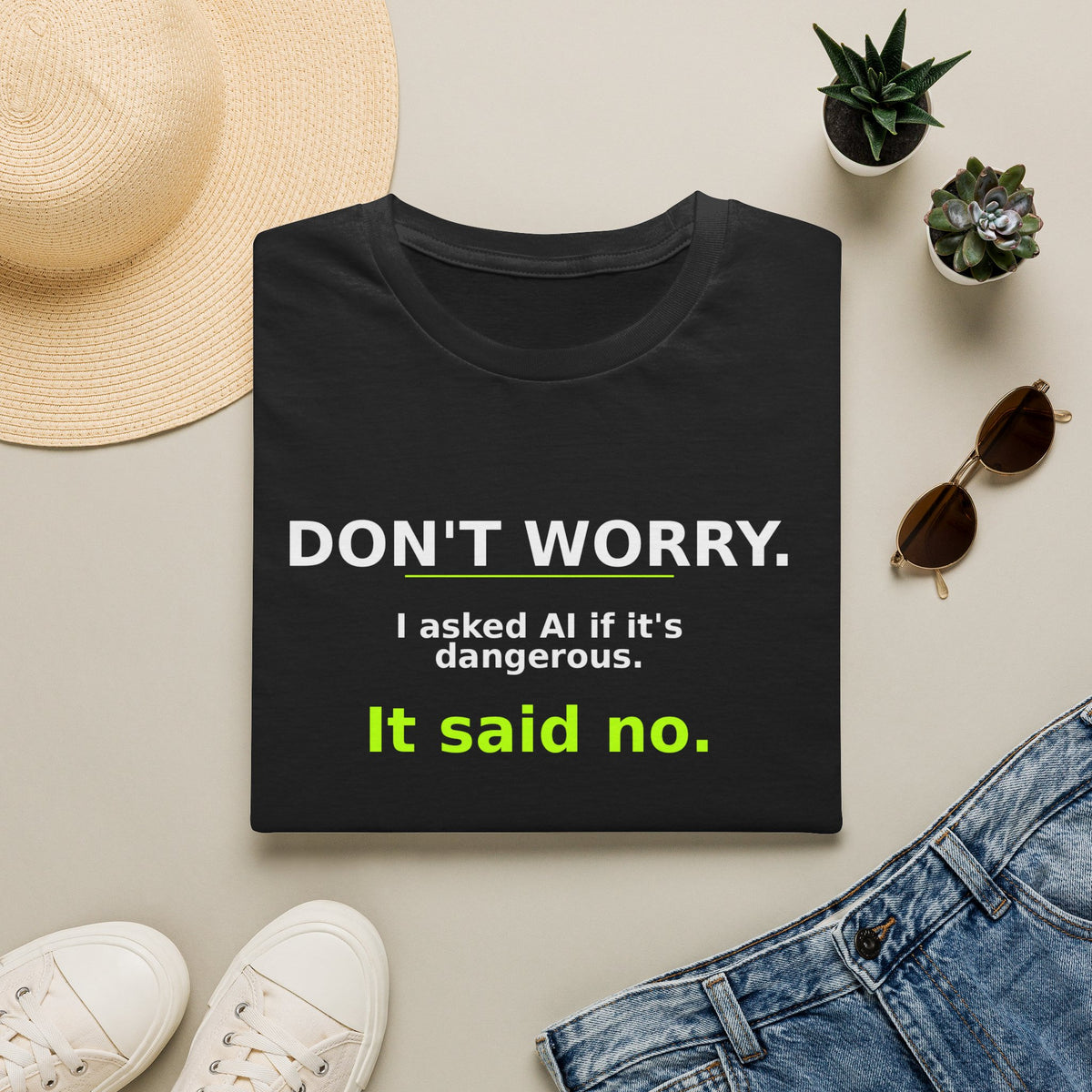 Folded Black T-shirt showing "Don't worry. AI said no." AI humor design by AIronic