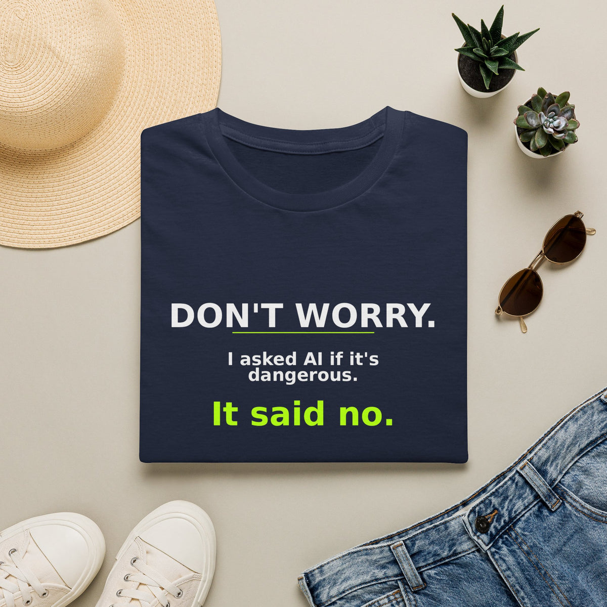 Folded Navy T-shirt showing "Don't worry. AI said no." AI humor design by AIronic