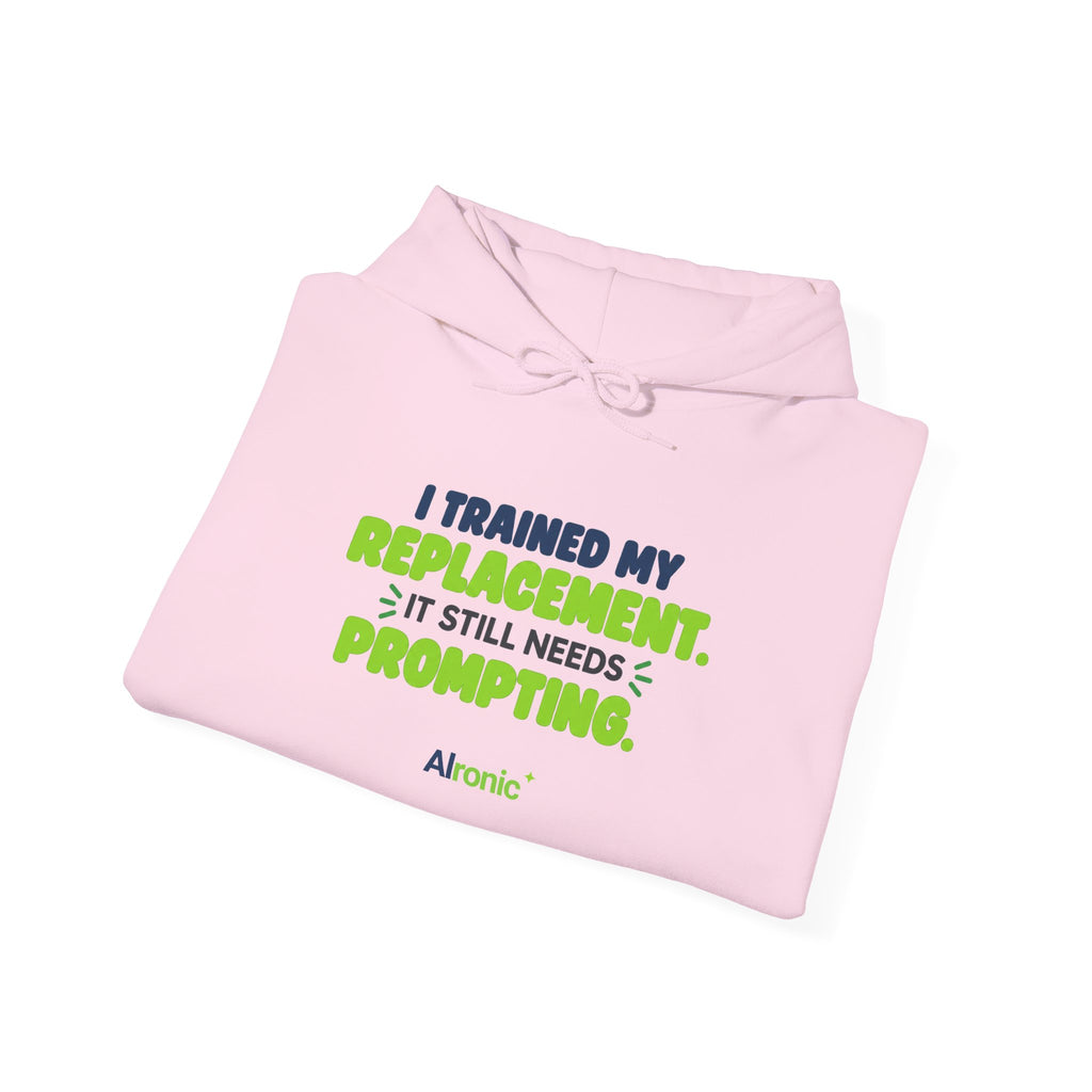 Light Pink hoodie featuring "I trained my replacement. It still needs prompting." AIronic design, folded detail view