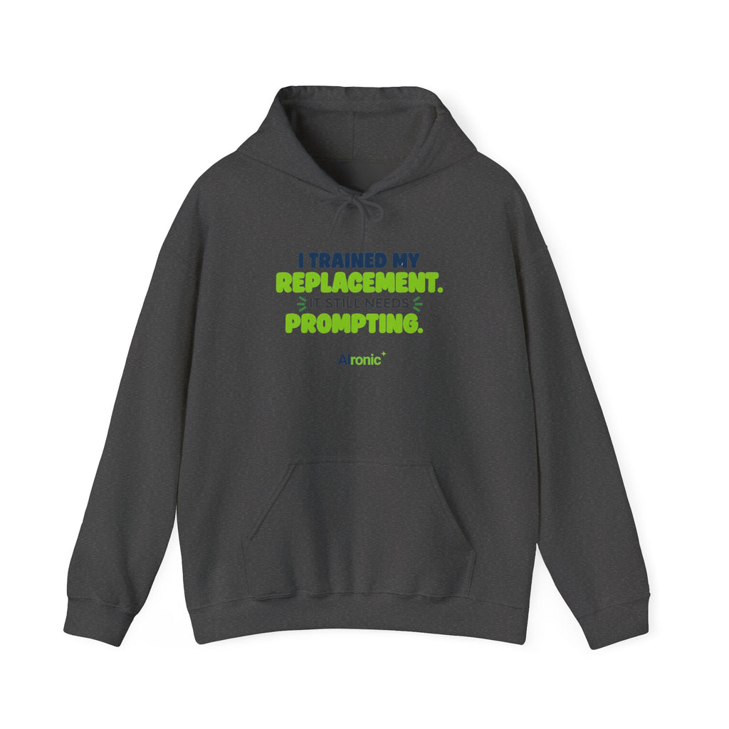 Dark Heather hoodie featuring "I trained my replacement. It still needs prompting." AIronic design, front view