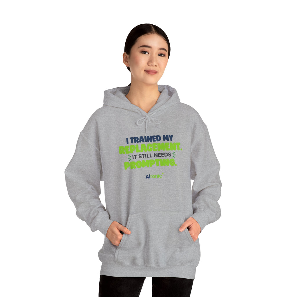 Sport Grey hoodie featuring "I trained my replacement. It still needs prompting." AIronic design, modeled front view