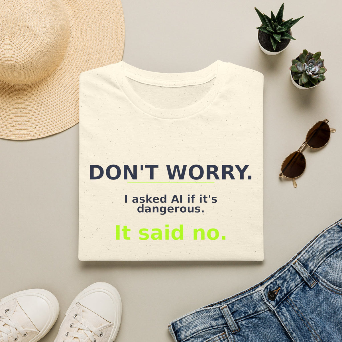 Folded Natural T-shirt showing "Don't worry. AI said no." AI humor design by AIronic