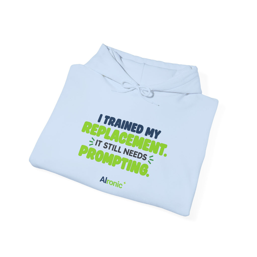 Light Blue hoodie featuring "I trained my replacement. It still needs prompting." AIronic design, folded detail view