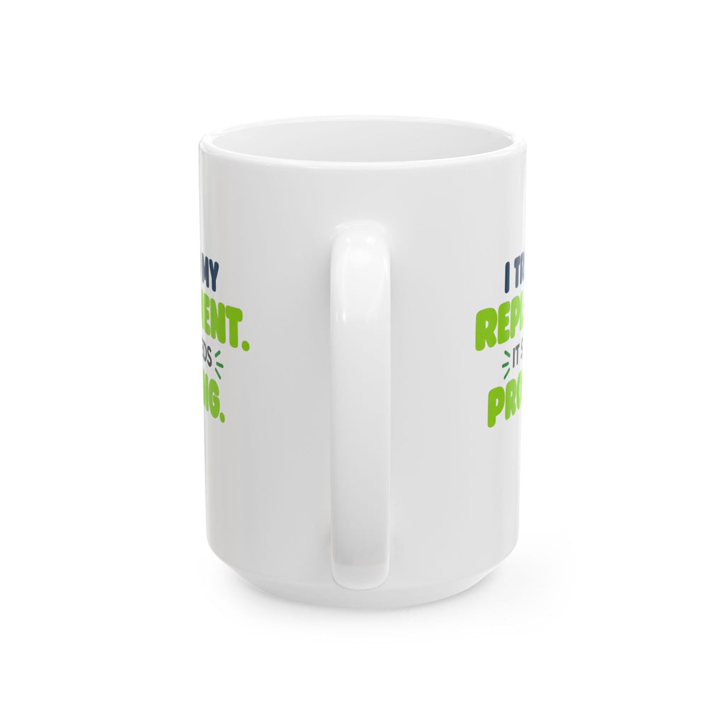 White ceramic mug featuring "I trained my replacement. It still needs prompting." AIronic design, opposite handle view